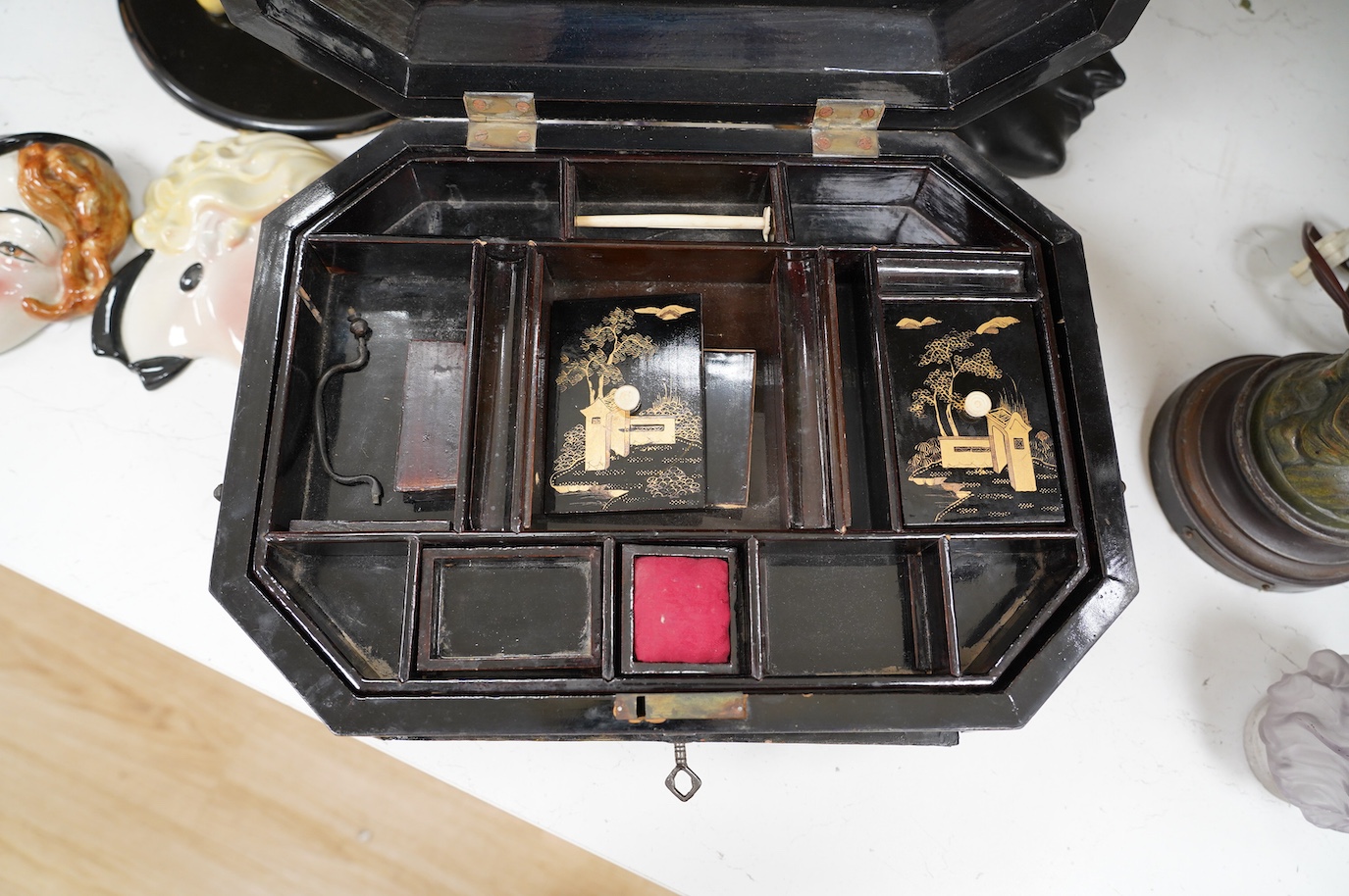 A Chinese black lacquer with gold decoration workbox, 36cm wide. Condition - one carved gilt paw foot missing to base